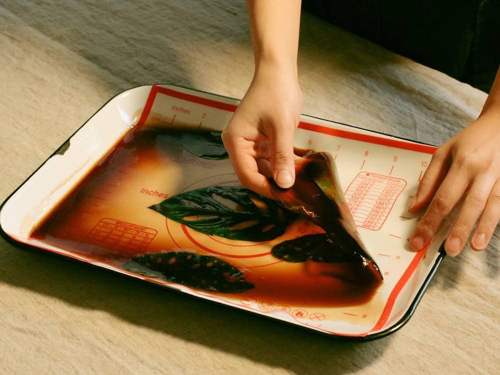 Renee peeling synthetic fabric off a pan