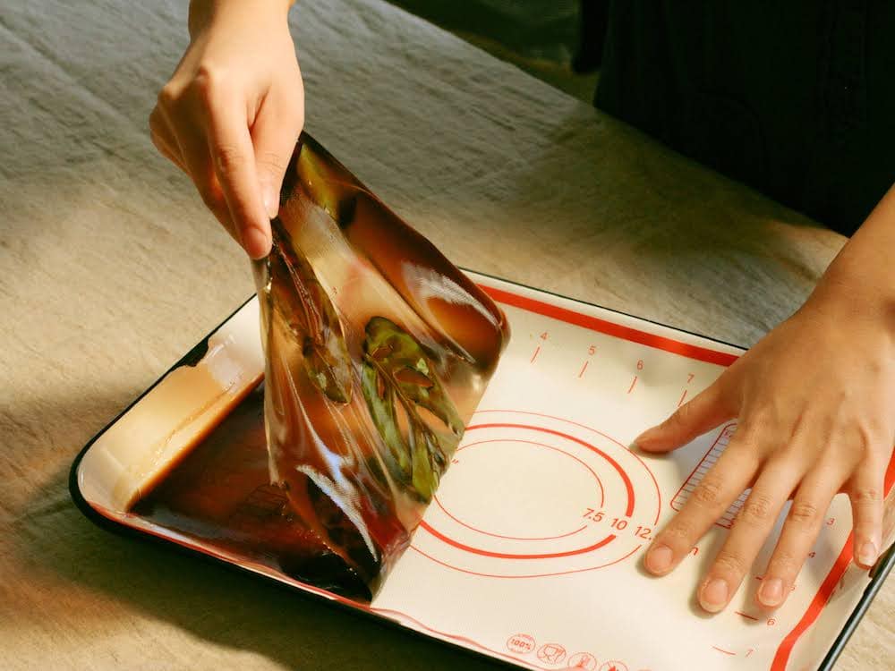 Renee peeling synthetic fabric off a pan