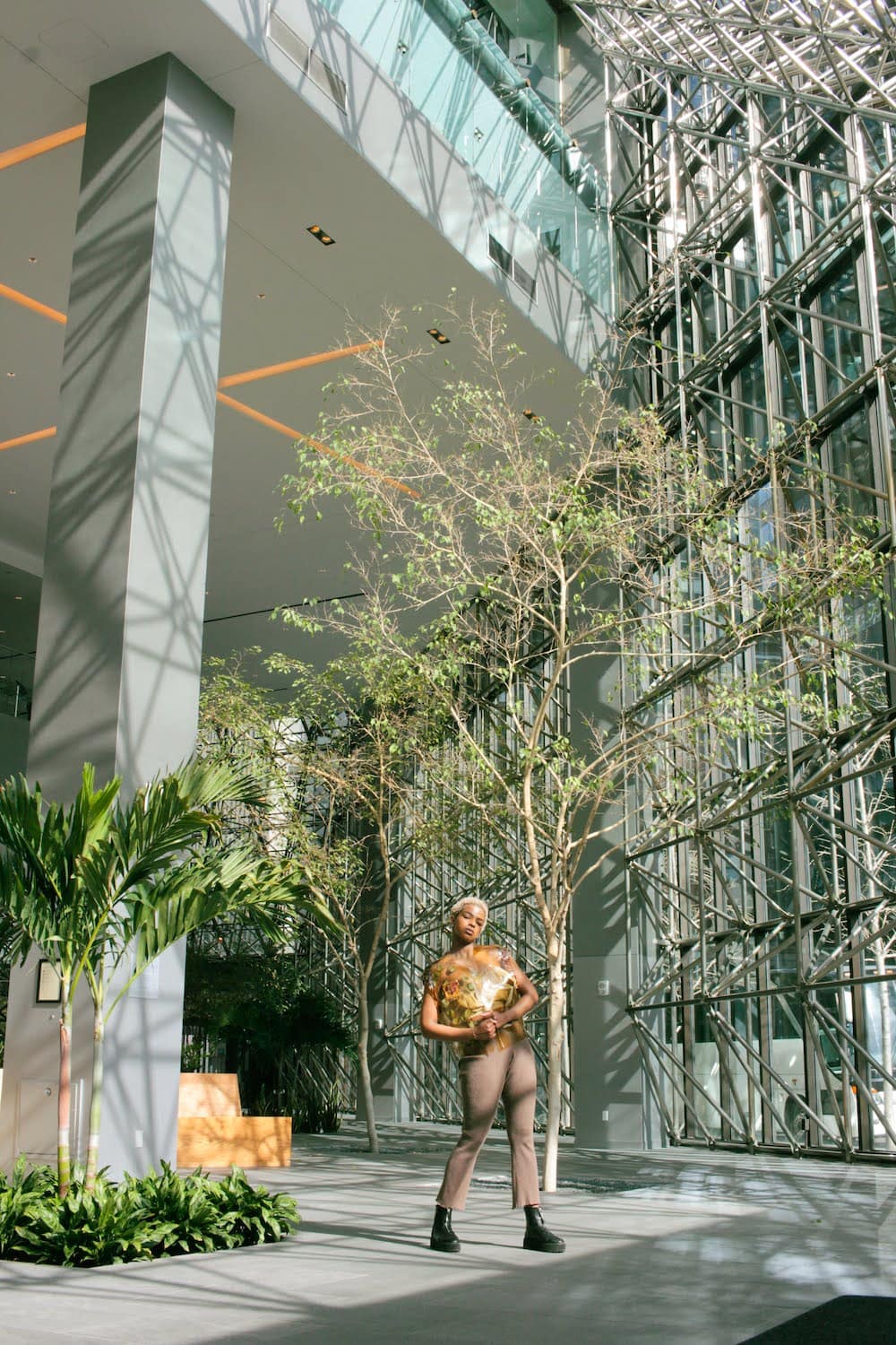 model posing inside greenhouse